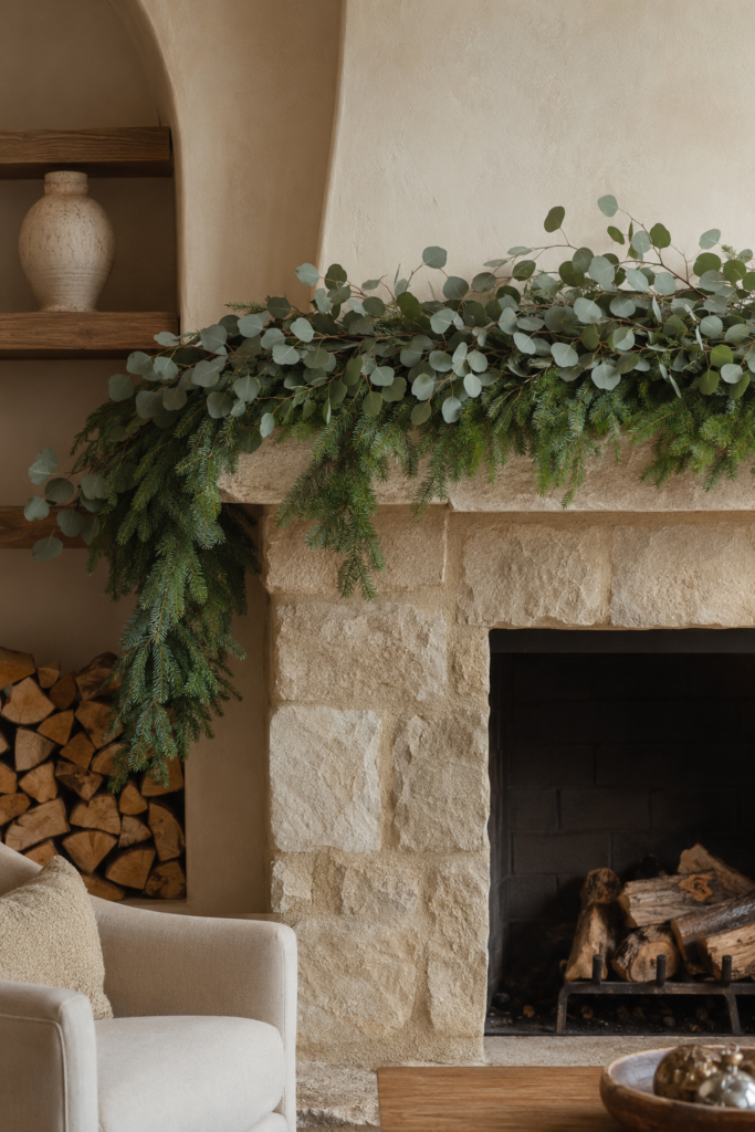 Layered Fraser fir and eucalyptus Christmas garland draped on a fireplace mantel