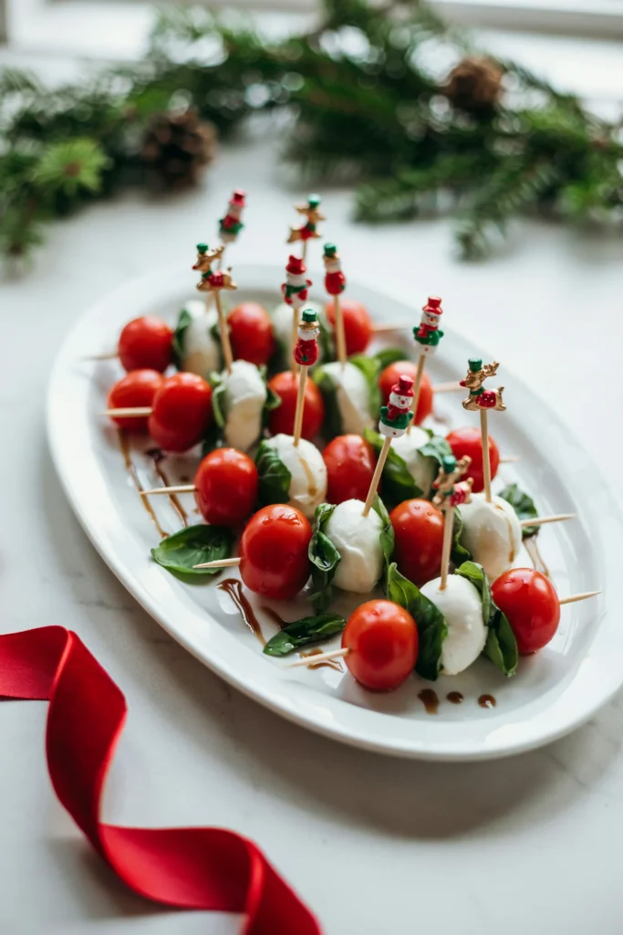 Christmas caprese skewers with cherry tomato, mozzarella, and basil drizzled with balsamic glaze