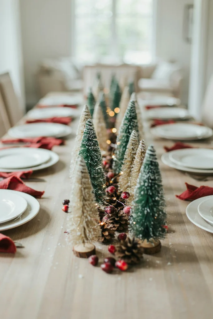 Cluster of flocked mini Christmas trees running down the table as a centerpiece