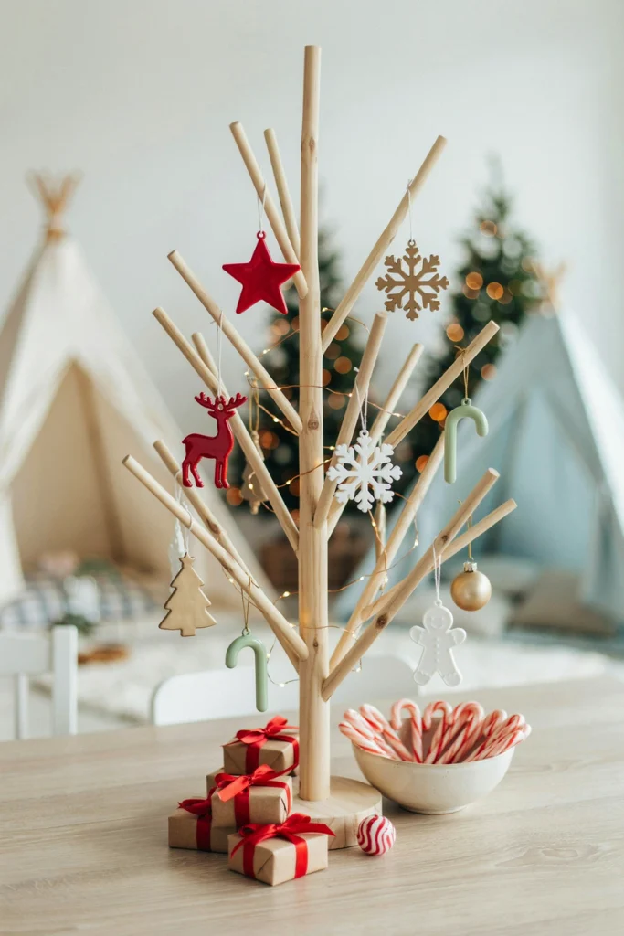 Tree branch hung with personalized glass ornament favors labeled with guest names
