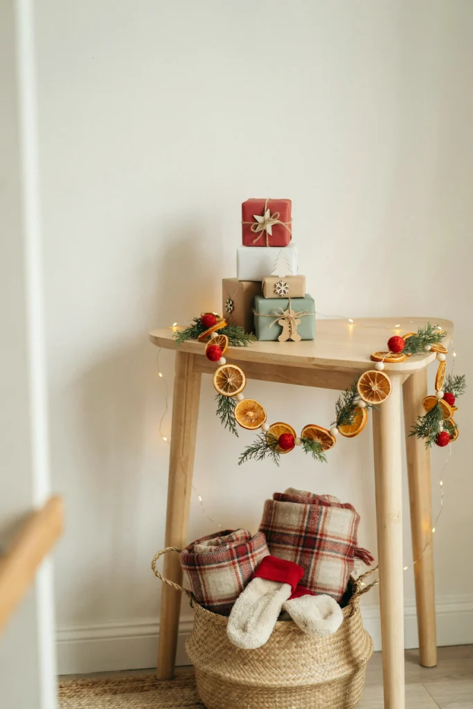 Entry table with numbered gift boxes, a welcome sign, and dried orange slice garland