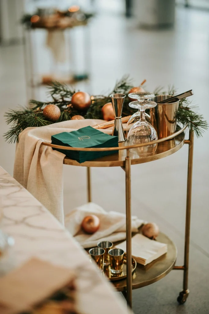 Stack of cocktail napkins on a bar cart stamped with a small gold monogram or company initial