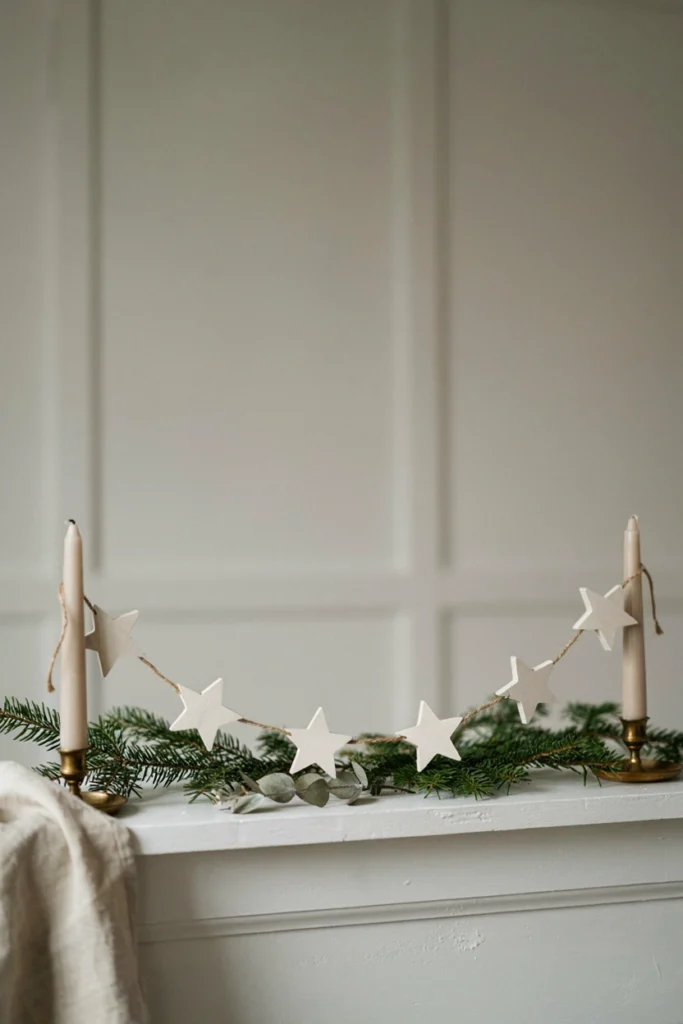 Garland of matte white cardboard stars cut from cereal boxes strung across a mantel