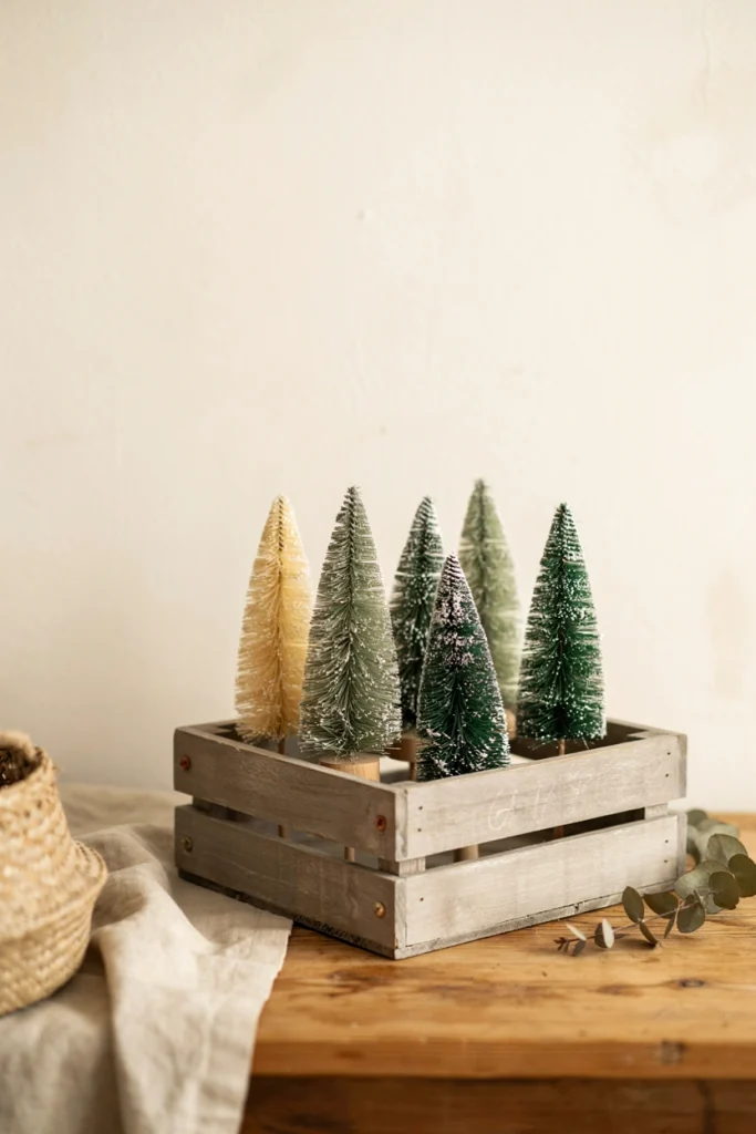 Miniature bottlebrush trees displayed upside down in a wood crate