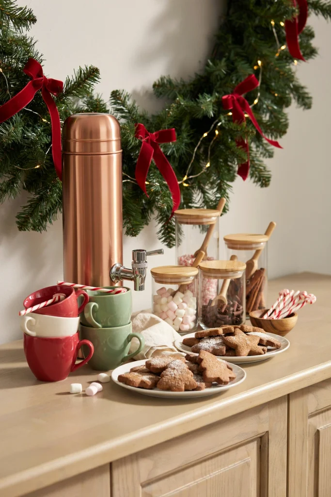 Hot cocoa station with vintage mugs, marshmallows, and a copper pitcher