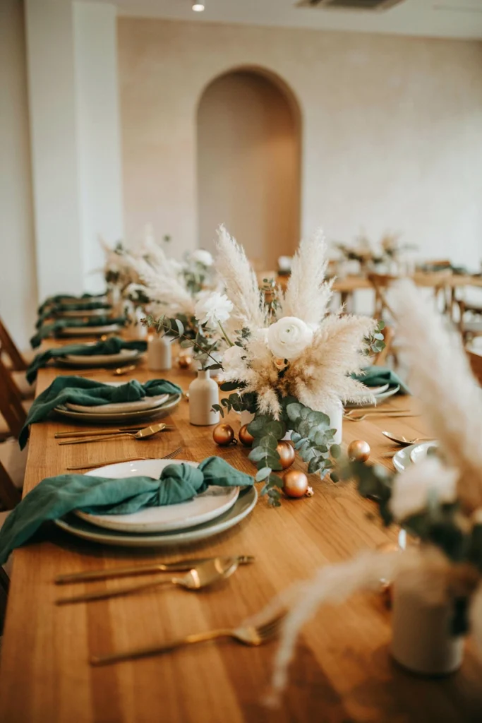 Tablescape in cream, sage, and natural wood tones with dried pampas grass and taper candles
