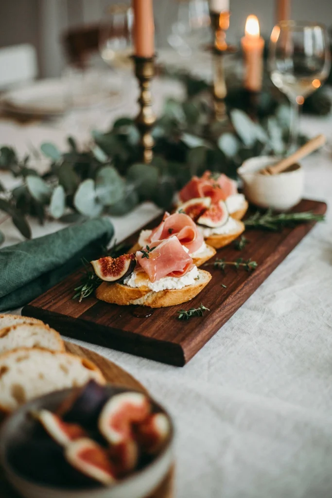Toasted baguette slices topped with creamy whipped ricotta, folds of prosciutto, and fig jam, drizzled with honey.